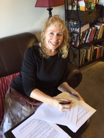 Elaine Marie Cooper signs a contract for Love's Kindling