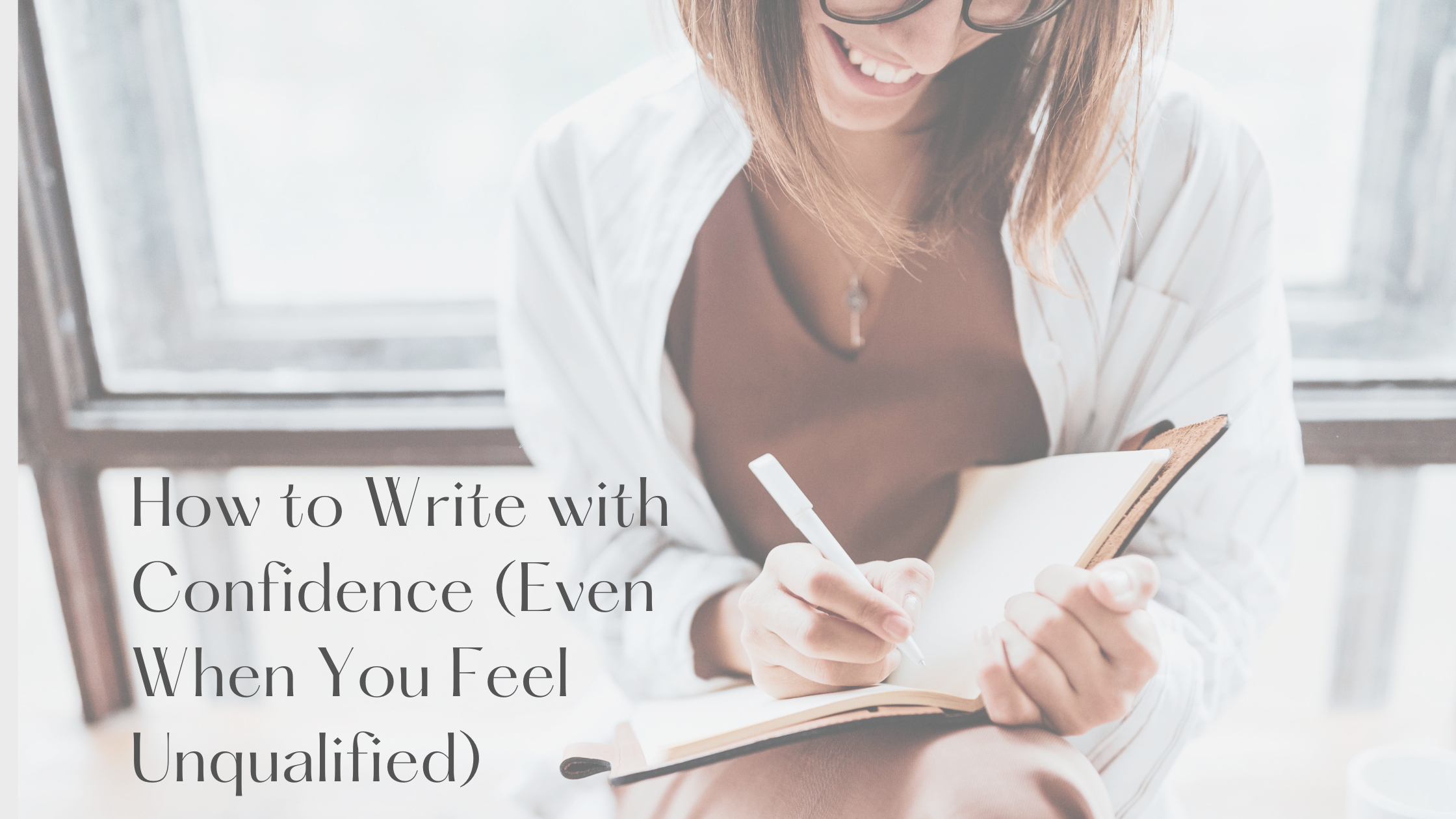 Smiling woman writing in a notebook while sitting by a window, symbolizing confidence in writing and encouragement for writers who feel unqualified.